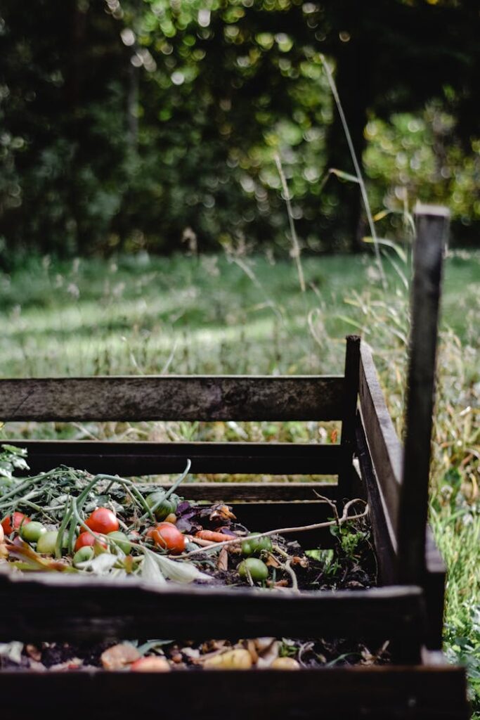 Wooden compost bin in an Estonian garden with organic waste and vegetables.